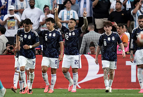 Argentina forward Lautaro Martínez (22) reacts after he scored on a penalty kick against Honduras during the first half of an international friendly soccer match in College Station, Texas. 