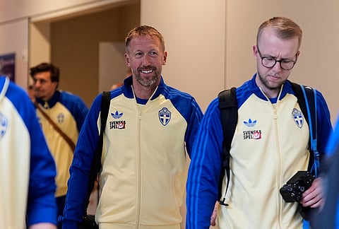 Sweden manager Graham Potter, center, smiles as he and men's national team walk past fans after arriving at Dallas Fort Worth International Airport in DFW Airport, Texas, ahead of the World Cup soccer tournament. 