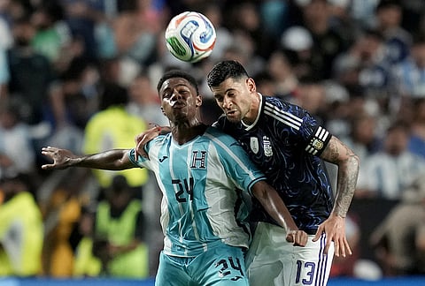 Honduras' Keyrol Figueroa (24) fights for a header against Argentina defender Cristian Romero (13) during the second half of an international friendly soccer match in College Station, Texas. 