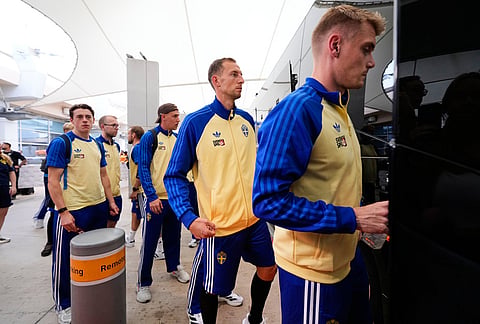 Gustaf Nilsson, center, and teammates board a bus after arriving at the Dallas Fort Worth International Airport, at DFW Airport, Texas, ahead of the World Cup soccer tournament. 