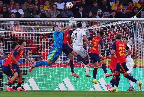 Spain and Iraq players duel for the ball during an international friendly soccer match in A Coruna, Spain.