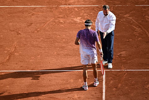 Italy's Flavio Cobolli checks a mark during the final tennis match against Germany's Alexander Zverev at the French Open in Paris.