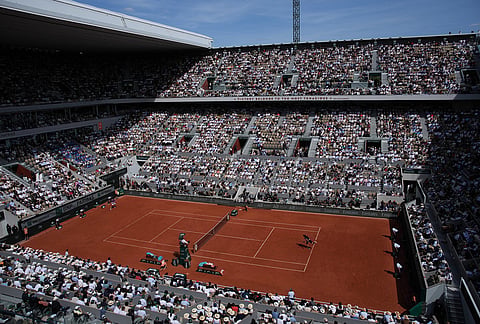 Alexander Zverev of Germany, right, serves to Flavio Cobolli of Italy during their men's final match at the French Open tennis tournament in Paris.