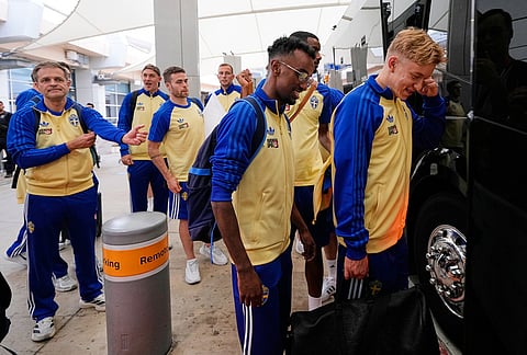 Taha Ali, center, and teammates board a bus after arriving at the Dallas Fort Worth International Airport, at DFW Airport, Texas, ahead of the World Cup soccer tournament. 