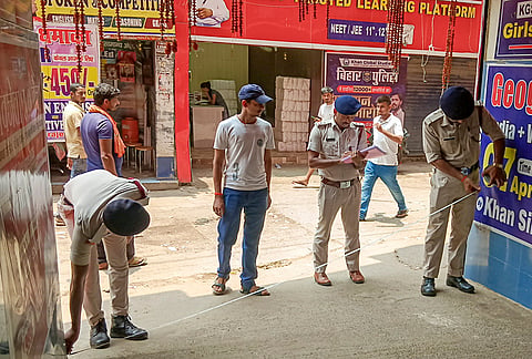 Police personnel stand guard at the campus of Khan Global Studies (KGS) coaching institute after an FIR was allegedly registered against educator Faisal Khan, popularly known as Khan Sir, and two others in connection with a firing and vandalism incident, in Patna, Bihar.
