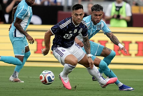 Argentina forward Lautaro Martínez (22) tracks down a pass as Honduras' Kervin Arriaga, right, defends during the first half of an international friendly soccer match in College Station, Texas. 