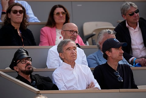 LVMH CEO Bernard Arnault, center, and his son Antoine Arnault, right, watch the men's final match between Flavio Cobolli of Italy and Alexander Zverev of Germany at the French Open tennis tournament in Paris.