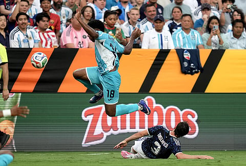 Honduras' Dereck Moncada (18) is slide-tackled near the sideline by Argentina's Nicolás Tagliafico (3) during the first half of an international friendly soccer match in College Station, Texas. 