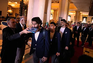 | Photo: AP/Khalil Hamra : Iran's players kiss the Muslim's holiest book Quran as they leave to Antalya airport, southern Turkey, before departing to Tijuana, Mexico, for the World Cup soccer tournament.