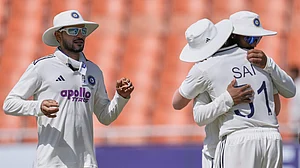 AP Photo/Ashwini Bhatia : India's captain Shubman Gill, left, reacts after India won the cricket test match against Afghanistan in New Chandigarh, India, Monday, June 8, 2026.
