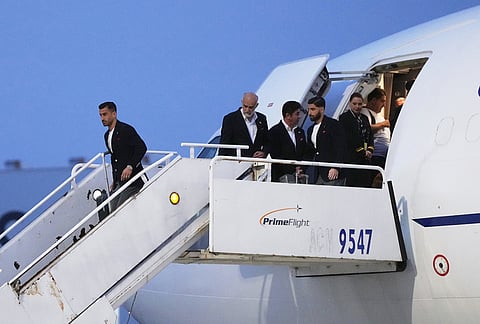 Iran's Ehsan Hajisafi, left, arrives with his teammates for the World Cup soccer tournament in Tijuana, Mexico.