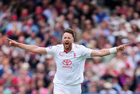 England's Ollie Robinson celebrates taking his fifth wicket, the wicket of New Zealand's Matt Henry during the second day of the test match between England and New Zealand at Lord's cricket ground in London.