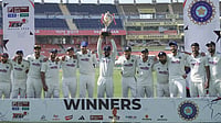 AP Photo/Ashwini Bhatia : India's Manav Suthar, center, lifts the winner's trophy alongside his teammates as they celebrate after winning the lone cricket Test match against Afghanistan in New Chandigarh, India, Monday, June 8, 2026.