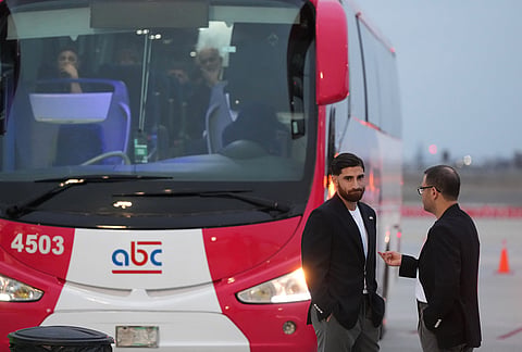 Iran's Alireza Jahanbakhsh, second from right, talks with a team official as he arrives with his teammates for the World Cup soccer tournament in Tijuana, Mexico.