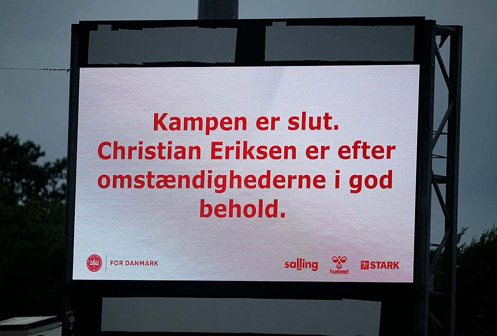 A sign reads that 'the match is over. Christian Eriksen is in good condition under the circumstances' after he collapsed on the field during the international friendly soccer match between Denmark and Ukraine in Odense, Denmark. - | Photo: Bo Amstrup/Ritzau Scanpix via AP