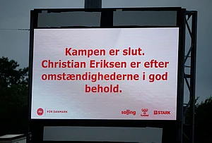 | Photo: Bo Amstrup/Ritzau Scanpix via AP : A sign reads that 'the match is over. Christian Eriksen is in good condition under the circumstances' after he collapsed on the field during the international friendly soccer match between Denmark and Ukraine in Odense, Denmark.
