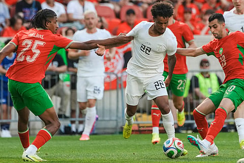 Norway midfielder Oscar Bobb (22) fights for the ball against Morocco defender Redouane Halal (25) and defender Youssef Belammari(19) during an international friendly soccer match in Harrison, N.J.