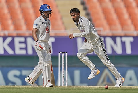 India's Manav Suthar runs to field a shot off his own bowling on day two of the cricket test match between Afghanistan and India in New Chandigarh.