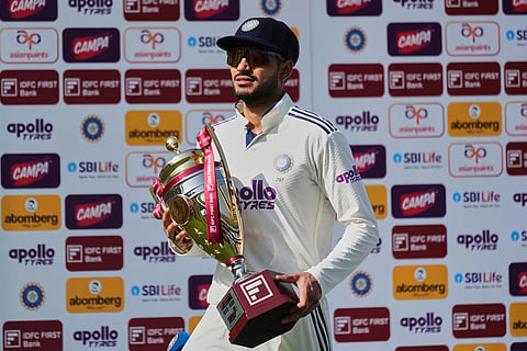 India's captain Shubman Gill poses with the winner's trophy after his team wins the lone cricket Test match against Afghanistan in New Chandigarh, India.