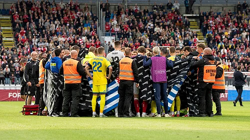 AP : Players from Denmark and Ukraine form a circle around Denmarks player Christian Eriksen after he collapsed during the international friendly soccer match between Denmark and Ukraine in Odense, Denmark, Sunday, June 7, 2026.