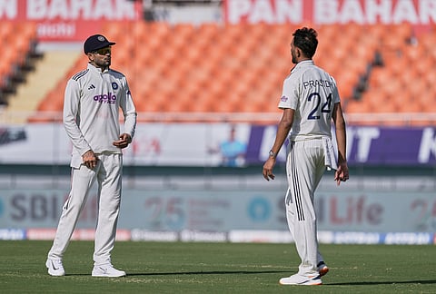 India's captain Shubman Gill, left, speaks to his bowler Prasidh Krishna on day two of the cricket test match between Afghanistan and India in New Chandigarh.
