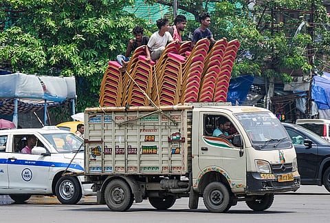 Worker sit atop on chair amid scorching summer heat, in Kolkata.