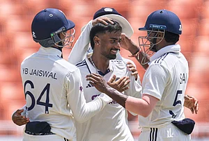 | Photo: AP/Ashwini Bhatia : India's Manav Suthar, center, is congratulated by teammates after taking his fifth wicket of the innings on day three of the cricket test match between Afghanistan and India in New Chandigarh.
