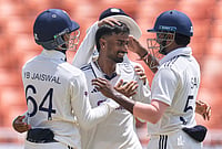 | Photo: AP/Ashwini Bhatia : India's Manav Suthar, center, is congratulated by teammates after taking his fifth wicket of the innings on day three of the cricket test match between Afghanistan and India in New Chandigarh.