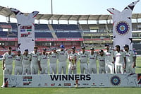 | Photo: AP/Ashwini Bhatia : India's Manav Suthar, center, lifts the winner's trophy alongside his teammates as they celebrate after winning the lone cricket Test match against Afghanistan in New Chandigarh, India.