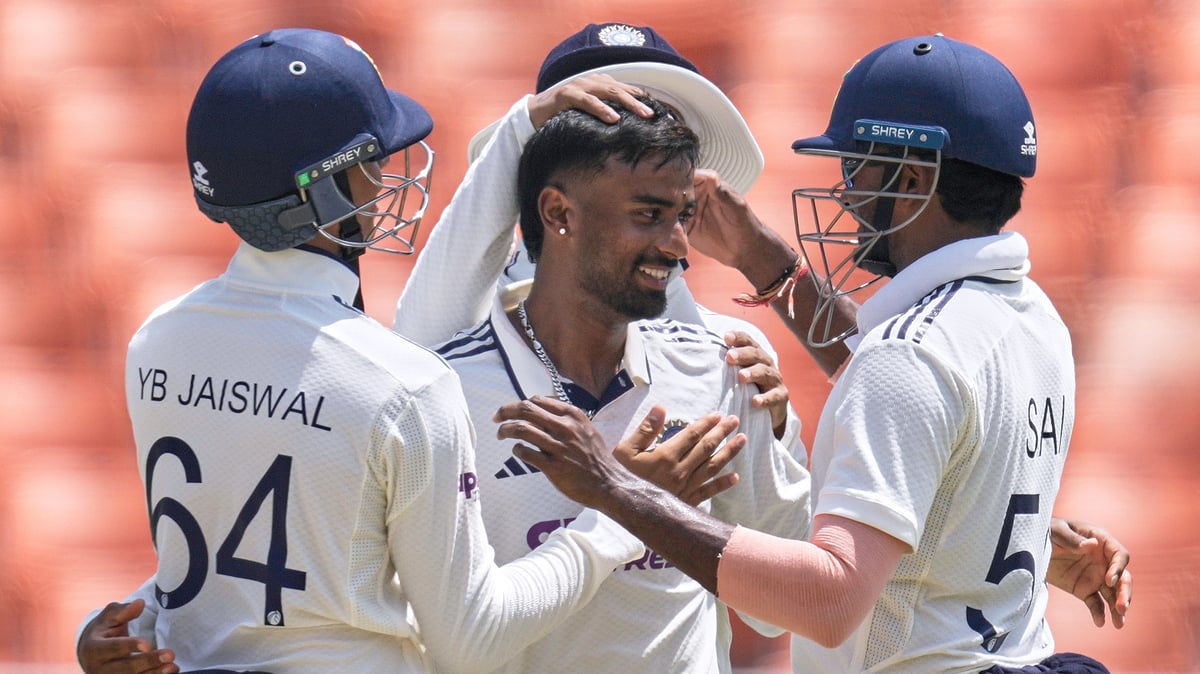 India's Manav Suthar, center, is congratulated by teammates after taking his fifth wicket of the innings on day three of the cricket test match between Afghanistan and India in New Chandigarh. - AP Photo