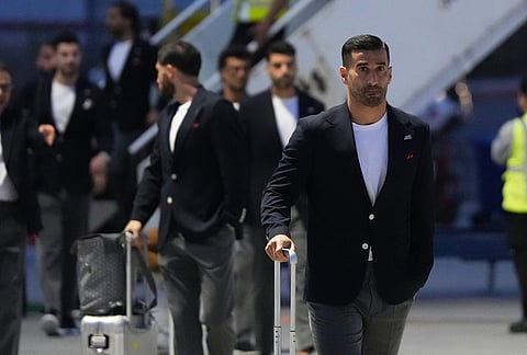 Iran's Ehsan Hajisafi, right, arrives with his teammates for the World Cup soccer tournament in Tijuana, Mexico.