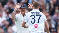 AP Photo : England's Gus Atkinson, right, celebrates with captain Ben Stokes after bowling out New Zealand's Matt Henry to win the Test match between England and New Zealand at Lord's cricket ground.