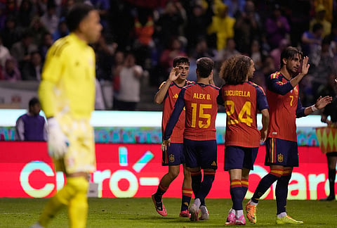 Spain's Pedri, rear left, is congratulated after scoring his side's second goal during an international soccer match against Peru in Puebla, Mexico.