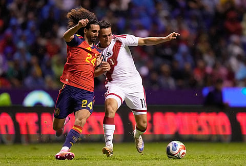 Spain's Marc Cucurella, left, and Peru's Jairo Velez, right, fight for the ball during an international friendly soccer match in Puebla, Mexico.