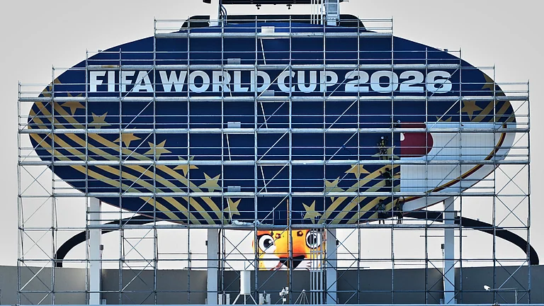 Workers cover a Kansas City Chiefs sign to FIFA World Cup 2026 as work continues to transform Arrowhead Stadium to Kansas City Stadium ahead of the FIFA World Cup soccer tournament. - AP Photo