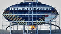 World Cup of Chaos: Ian Wright Tears Into FIFA And Co-Hosts USA For Visa Restrictions And Ticket Revocations AP Photo : Workers cover a Kansas City Chiefs sign to FIFA World Cup 2026 as work continues to transform Arrowhead Stadium to Kansas City Stadium ahead of the FIFA World Cup soccer tournament.