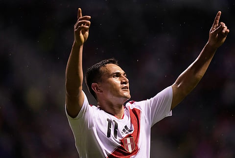 Peru's Jairo Velez celebrates after scoring his side's first goal during an international soccer match against Spain in Puebla, Mexico.