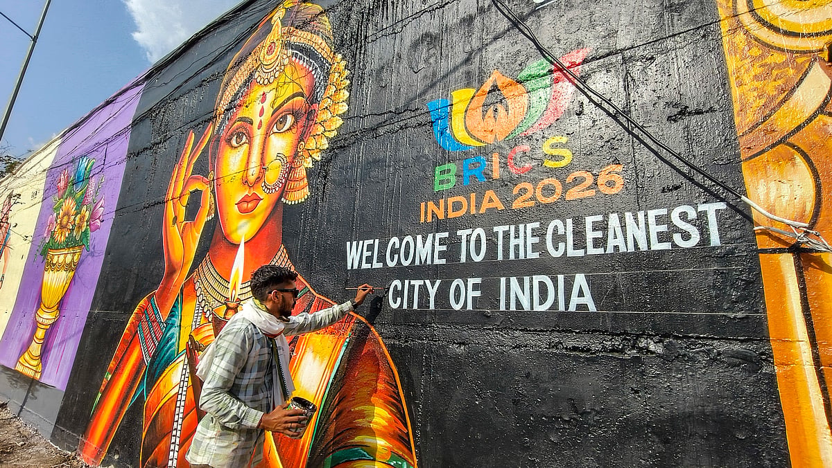 An artist paints a mural on a roadside wall as preparations are underway for the 'BRICS Agriculture Meetings 2026', in Indore, Madhya Pradesh, Monday, June 8, 2026. - (PTI Photo) 