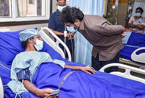 Andhra Pradesh Deputy Chief Minister Pawan Kalyan meets a person injured in the Rashtriya Ispat Nigam Ltd (Vizag Steel Plant) accident. 
