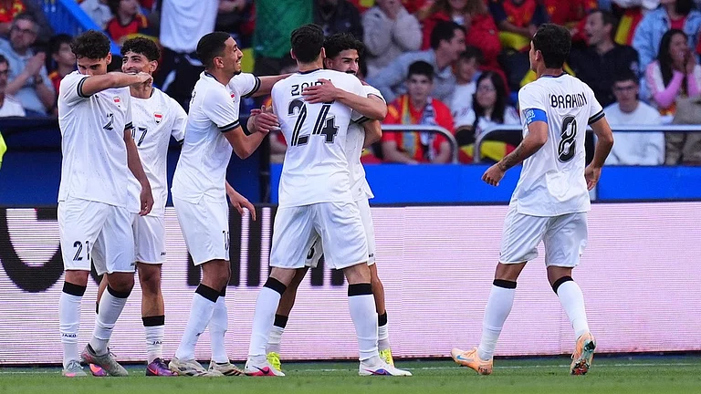 Iraq players celebrate their first goal against Spain during an international friendly soccer match in A Coruna, Spain. - AP Photo