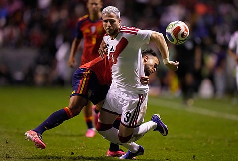 Spain's Eric Garcia, left, and Peru's Adrian Ugarriza compete for the ball during an international soccer match in Puebla, Mexico.