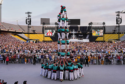 Performers make a human tower, known as Castells, for Pope Leo XIV as he leads a vigil of prayer at the Lluis Companys Olympic Stadium, in Barcelona.