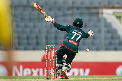 Bangladesh's Towhid Hridoy reacts after hit by the ball during the first one day international cricket match between Australia and Bangladesh in Mirpur, Bangladesh.