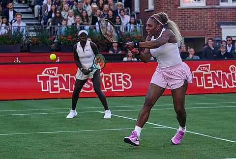 Serena Williams of the United States, right, hits a return as she and playing partner Victoria Mboko of Canada play against Nicole Melichar-Martinez of Canada and Erin Routliffe of New Zealand during their first round doubles match at the Queen's Club tennis championships in London.