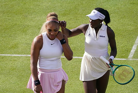 Serena Williams of the United States, left, talks to playing partner Victoria Mboko of Canada as they play against Nicole Melichar-Martinez of Canada and Erin Routliffe of New Zealand during their first round doubles match at the Queen's Club tennis championships in London.