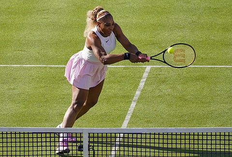 Serena Williams of the United States, hits a return as she and playing partner Victoria Mboko of Canada play against Nicole Melichar-Martinez of Canada and Erin Routliffe of New Zealand during their first round doubles match at the Queen's Club tennis championships in London.