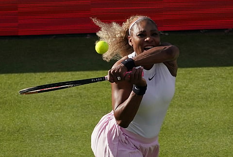 Serena Williams of the United States, hits a return as she and playing partner Victoria Mboko of Canada play against Nicole Melichar-Martinez of Canada and Erin Routliffe of New Zealand during their first round doubles match at the Queen's Club tennis championships in London.