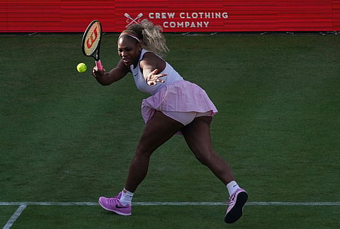 Serena Williams of the United States, hits a return as she and playing partner Victoria Mboko of Canada play against Nicole Melichar-Martinez of Canada and Erin Routliffe of New Zealand during their first round doubles match at the Queen's Club tennis championships in London.