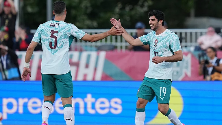 Portugal's Goncalo Guedes, right, celebrates with team mate Diogo Dalot after scoring his side's opening goal during an international friendly soccer match between Portugal and Chile in Oeiras, outside Lisbon. - AP Photo
