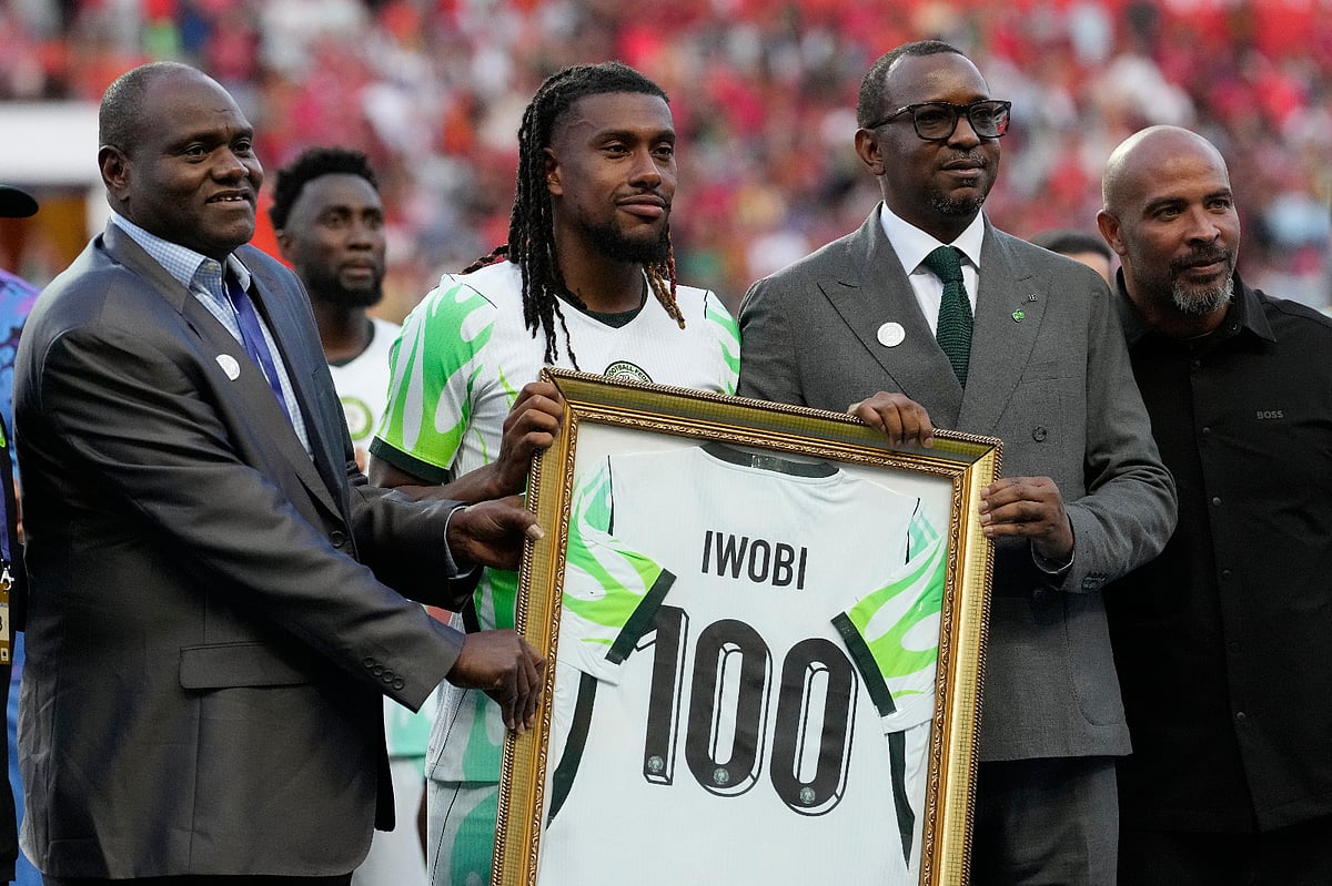 Officials present Nigeria's Alex Iwobi with a 100-cap plaque before an international friendly soccer match between Portugal and Nigeria in Leiria.
